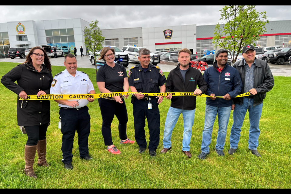 The Protective Services Building was officially open to the public Tuesday. Marking the opening of the facility was the official cutting of the ‘caution’ tape. (Left to right) Lac La Biche County, Coun. Charlyn Moore; Enforcement Services manager, Chris Clark; firefighter, Natasha Downs; Protective Services Manager, John Kokotilo; Lac La Biche County Mayor, Paul Reutov; Lac La Biche County councillors'  John Mondal and Sterling Johnson.