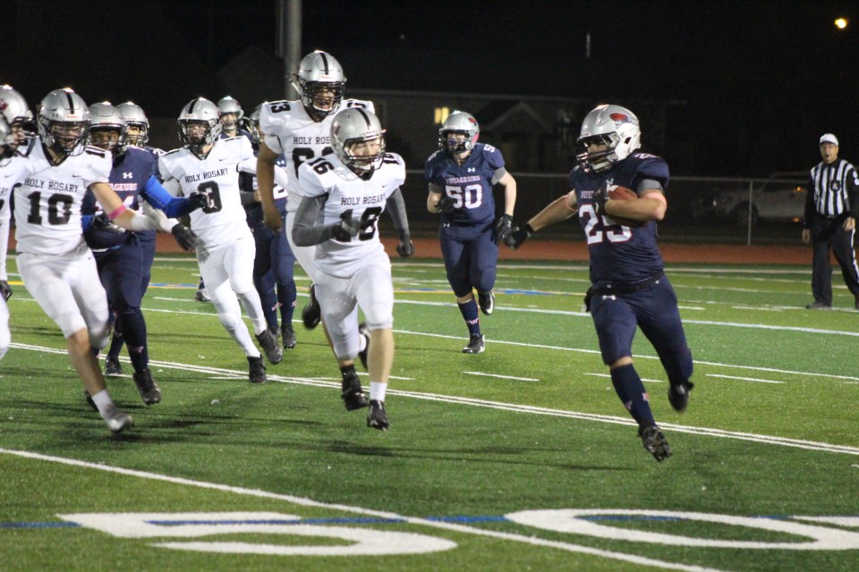 Donavan Morgan, player #25 for the Voyageurs, gains yards as he pushes down the Walsh Field.