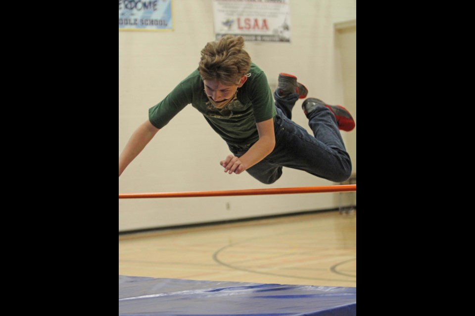 Superman dives over the high jump bar get tricky as the bar goes up.