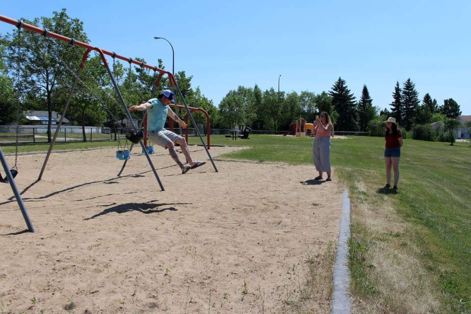Chris Funk jumps off the swing while Team Super Strike Power Force of Justice team member Michaela Bourbou takes his photo and Jaqueline Funk watches. This completed the Swing Mission for them that required the team to take a photo of someone mid-jump off a swing.