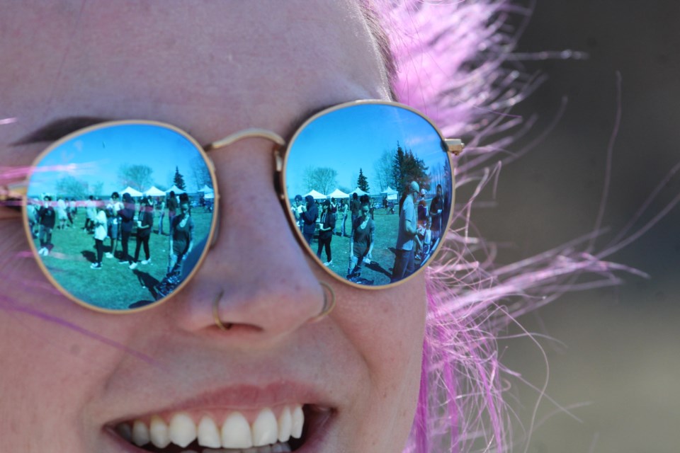 Lac La Biche's Hope Haven Women's Shelter outreach support worker Carly Moller is all smiles as she looks out on the crowds at Wednesday's Chalk the Walk event. Hope Haven was one of several regional agencies providing information and warm-weather treats to event attendees.