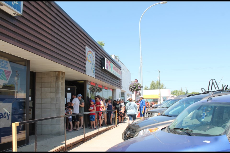 The lure of free pizza or pasta had a lineup stretching from the door of Magic Pizza to well around the north side of the block, this second annual event a generous gesture of thanks for the community’s continued patronage through the pandemic.