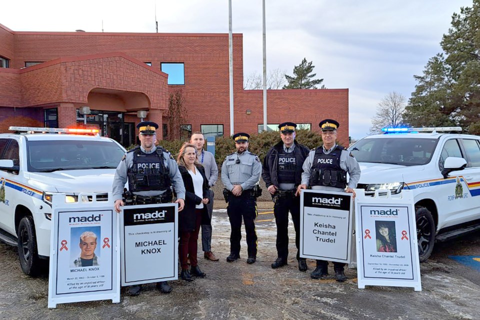 (Left) Cpl. Schneider with the St. Paul Detachment, Dianne Belanger, Community Leader MADD St. Paul & Area, Steven Duquette, volunteer MADD St. Paul & Area, Sgt. Montgomery with St. Paul Traffic Services, Cpl. Cunningham with the St. Paul Detachment, and Cpl. Schmidt with St. Paul Traffic Services stand next to two signs that will be used at check stops to remind people of the devastating consequences of impaired driving.