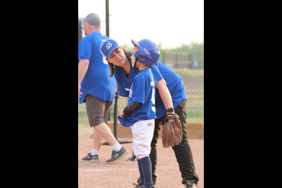 Lac La Biche Dodgers U9 Team 1 coach Cheryl Kuraitis gives some batting pointers to player Iggy Sarda-Nowak during Thursday's game.