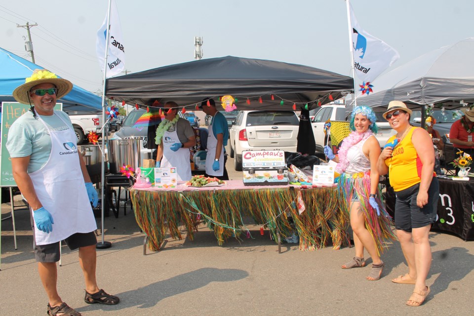 Canadian Natural Resources chose a Hawaiian theme, complete with a grass-skirted hula dancer, lifeguard and flower leis, to serve up their Team Spirit winning entry. / Vicki Brooker photo