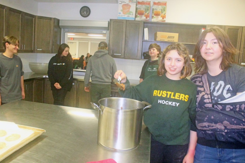 One team of teenage chili-cookers get ready to check their recipe before judges take the taste test at Friday's Teen Chill Zone Chili Cookoff.