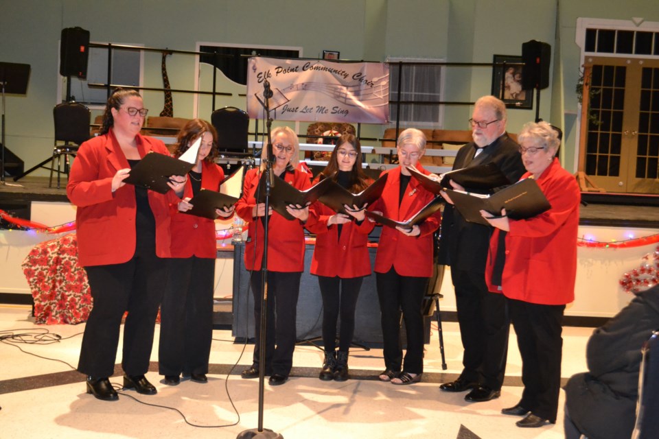 Seven voices combined in two jazzy bell carols midway through the concert. Left to right are Kelsey Taylor, Beckah Hatch, Dixie Coleman, Solene Beland, Natalle Beland, Udo Mueller and Sheila Hatch.