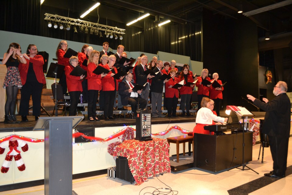 Oriane Beland and Kelsey Taylor accompany the Elk Point Community Choir on flutes in a lively rendition of ‘Christmas in Killarney’ with the choir’s youngest-ever page-turner, Lilly Taylor assisting pianist Sheila Hatch and Udo Mueller conduct