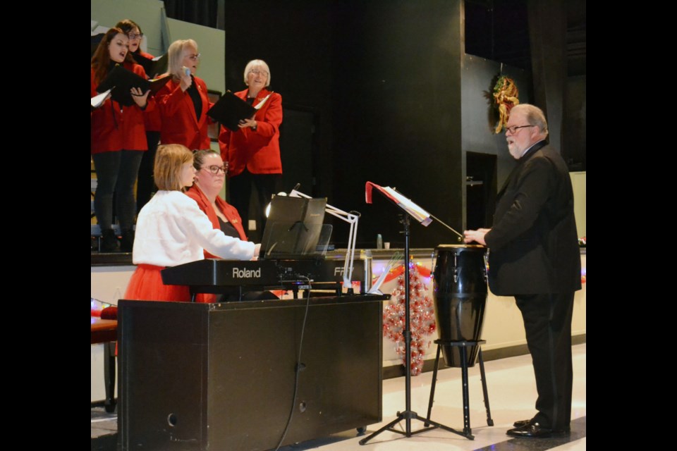 Three generations  - conductor and percussionist Udo Mueller, daughter Kelsey Taylor and granddaughter Lilly Taylor – combined their talents in the concert’s final number,  ‘African Advent Carol’, with Dixie Coleman, (third from left in top row) adding to the rhythm with the shakers.