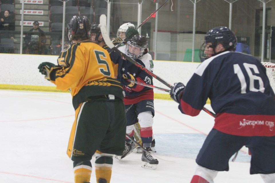 Clippers forward Keanu Foulds gets wrapped up in front of the Wheat Kings net.