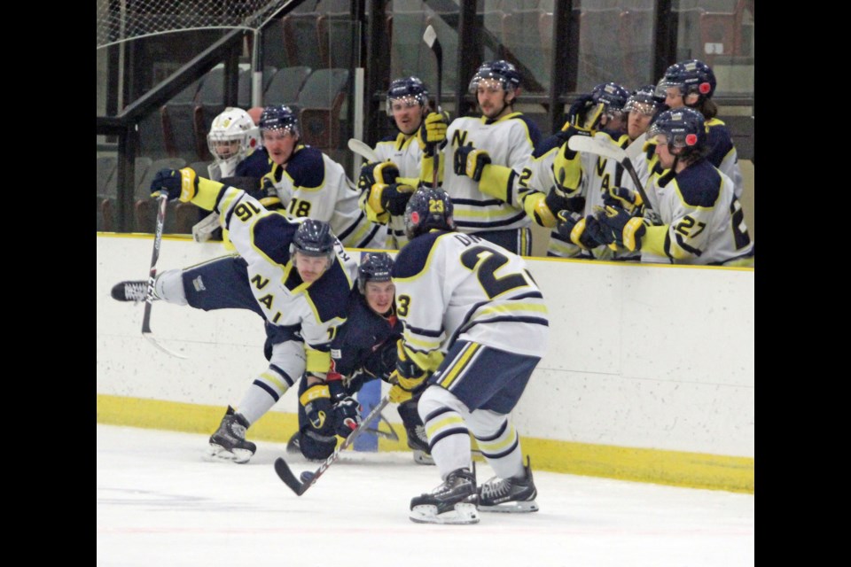 Voyageurs' Ty Budai squeezes between a NAIT forecheck during Friday night's 3-0 loss on home ice.