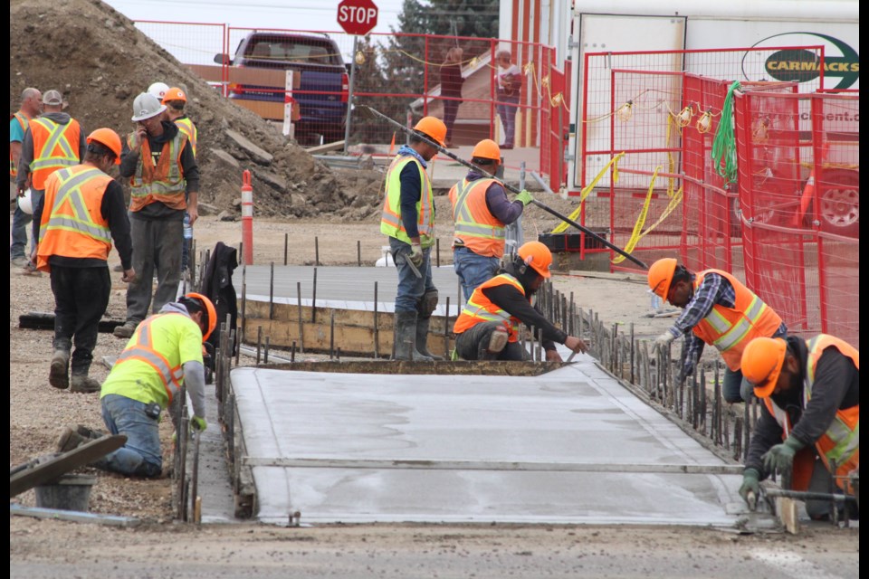 Concrete, poured by local company A&T Construction this week, gets set into sidewalk frames by crews working on the downtown upgrades. The sidewalks and other features of the $31.5 million project will need time to settle, say local officials.  Image Rob McKinley