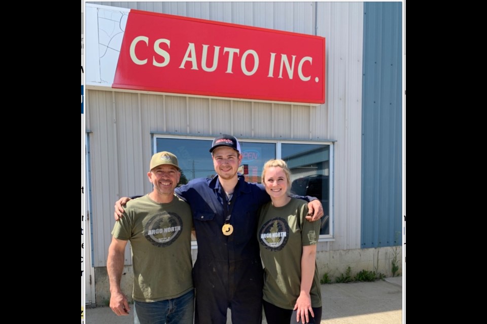 Corbin St. Jean, a Plamondon mechanic poses with his father Lee St. Jean and sister Saterra outside the family's auto repair shop, showing off the gold medal he received after competing in Skills Alberta automobile technology category. St. Jean also received a bronze in the same category from Skills Canada, which was announced earlier this week.