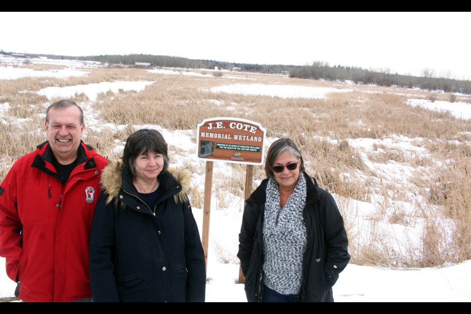 Colin, Val and Rosalie Cote at the sign honouring their family's donation and their father's legacy.