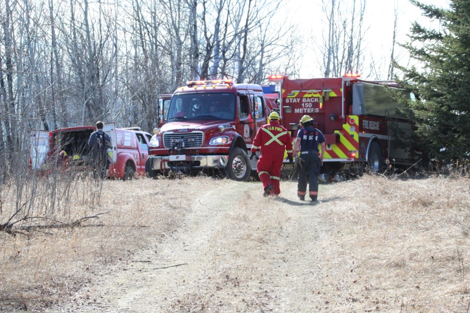 Municipal fire crews augment at the eastern edge of property along the Old Mission Road as a wildland fire scorched up several acres and burned down at least one out-building.