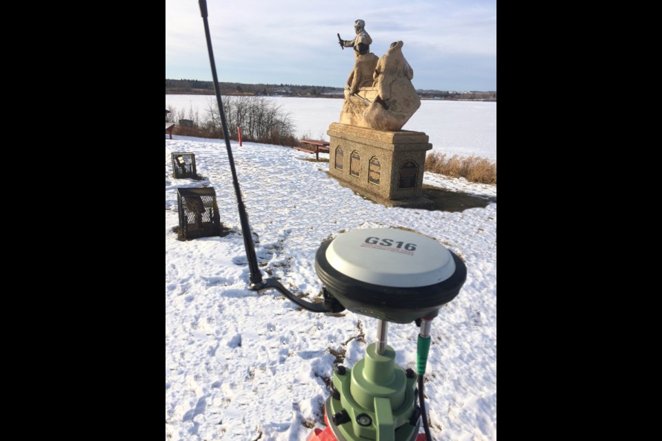 A digital survey control device sits beside the David Thompson statue on Churchill Drive.