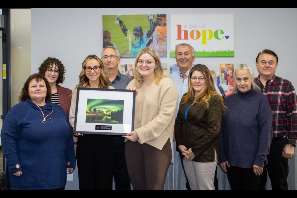 Representatives of the Dragonfly Centre accepted a Friends of Education award from Northern Lights Public Schools during the Jan. 17 board meeting. Pictured are: (back row) Board Chair Karen Packard, Trustee Blair Norton, Trustee Ron Young, Trustee Roy Ripkens. (Front row) Trustee Lois Phillips, Mikaela Norton, Senior Manager of Operations for Dragonfly Centre, Jessie Heisler, Prevention and Community Engagement Manager for Dragonfly Centre, Trustee Cheryl Edwards, and Trustee Debra Lozinski.