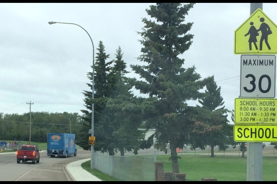 Motorists drive into a Lac La Biche County school zone just prior to the lunchtime 30kmh speed restrictions. Local police are monitoring speed, school bus safety and pedestrian traffic in school zones.