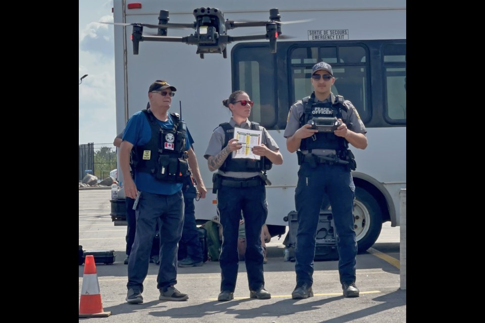 Randell Green of Volatus Aerospace Corporation supervises peace officers Melissa Young and Hussein Ismail as they practice safe drone flying techniques during a drone certification course which took place recently at Lac La Biche Protective Services. Three peace officers and three firefighters participated in the course. Submitted photo.