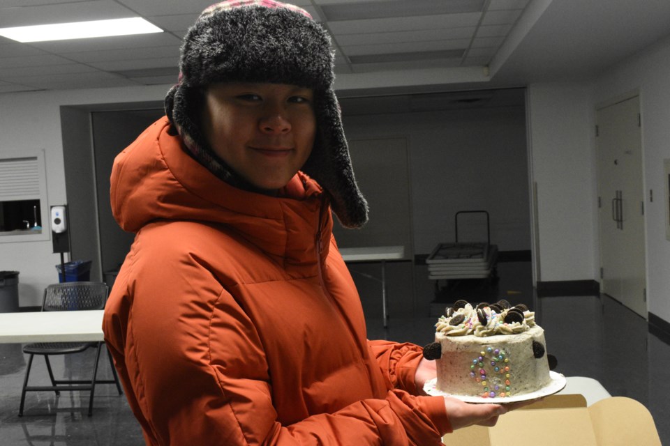 Logan Luong (12) posing with his cake. 