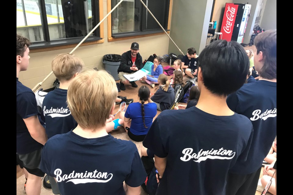 Ecole Plamondon Hawks badminton players listen to Hawks coach Steven Reid during last Thursday's Junior Wards. 