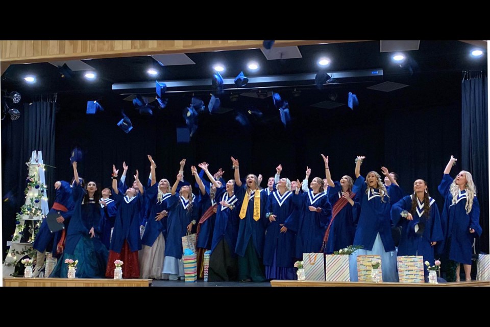 Two dozen École Plamondon graduates toss their caps to the ceiling of Plamondon' s Festival Centre during Saturday's convocation ceremony.