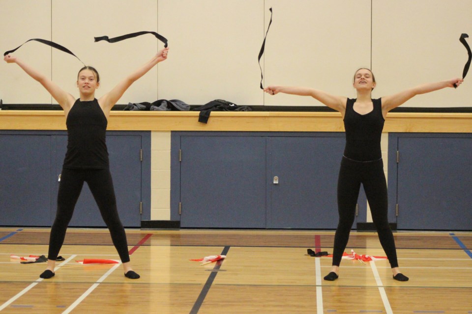 (left to right) Sisters Brooke and Karly Tluchak grabbed some ribbons during their routine.  Photo by Robynne Henry