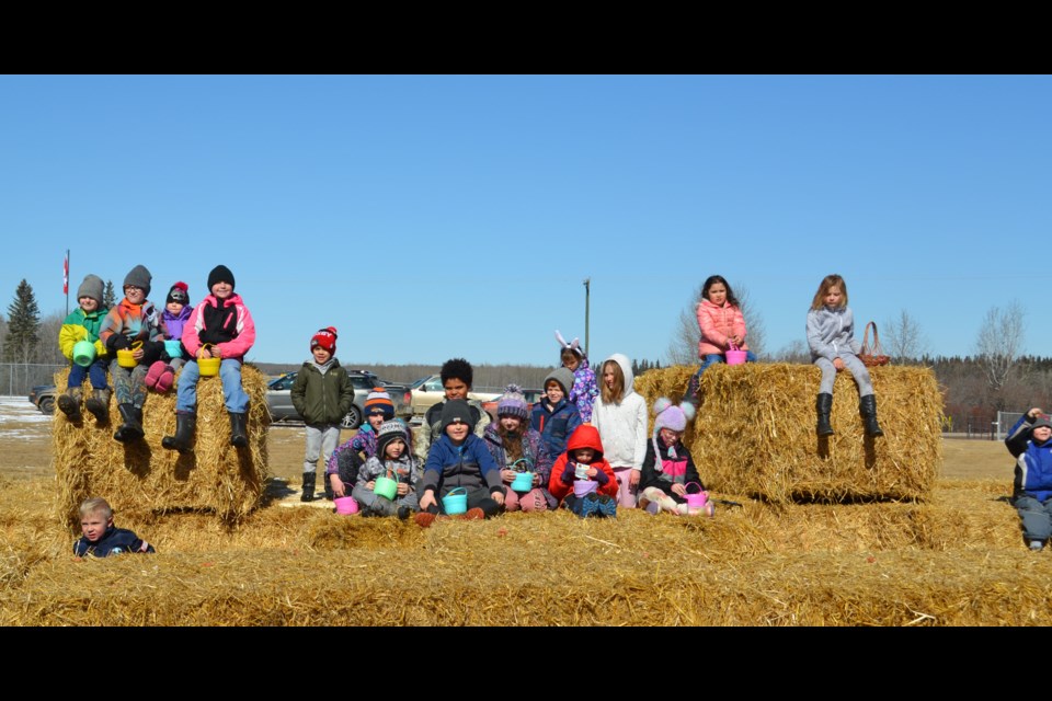 Happy egg hunters all lined up on Ferguson Flats bale maze when all the brightly coloured plastic eggs had been tracked down, before heading into the community hall to enjoy hot dogs and receive some Easter treats. There were treats for adults, too, with Diane Dewan winning the door prize and Jessica Morris the lucky winner of the ham raffle.