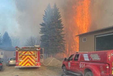 Fire crews battle to save a home and buildings near Caslan as the flames advance. Fire official say the home was saved.        Photo: submitted