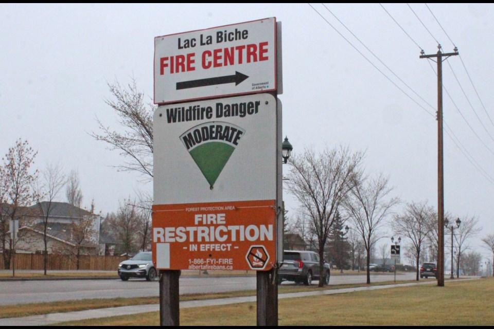 Vehicles drive along BeaverHill Road near the Lac La Biche Fire Centre on Tuesday during a recent rain shower. The precipitation dropped the fire hazard to moderate and helped to being the green-up process in the area.