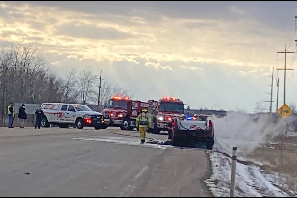 Fire crews and emergency responders block the highway at the scene of a fire involving at least one vehicle near the Lac La Biche Agricultural Grounds on Saturday evening.