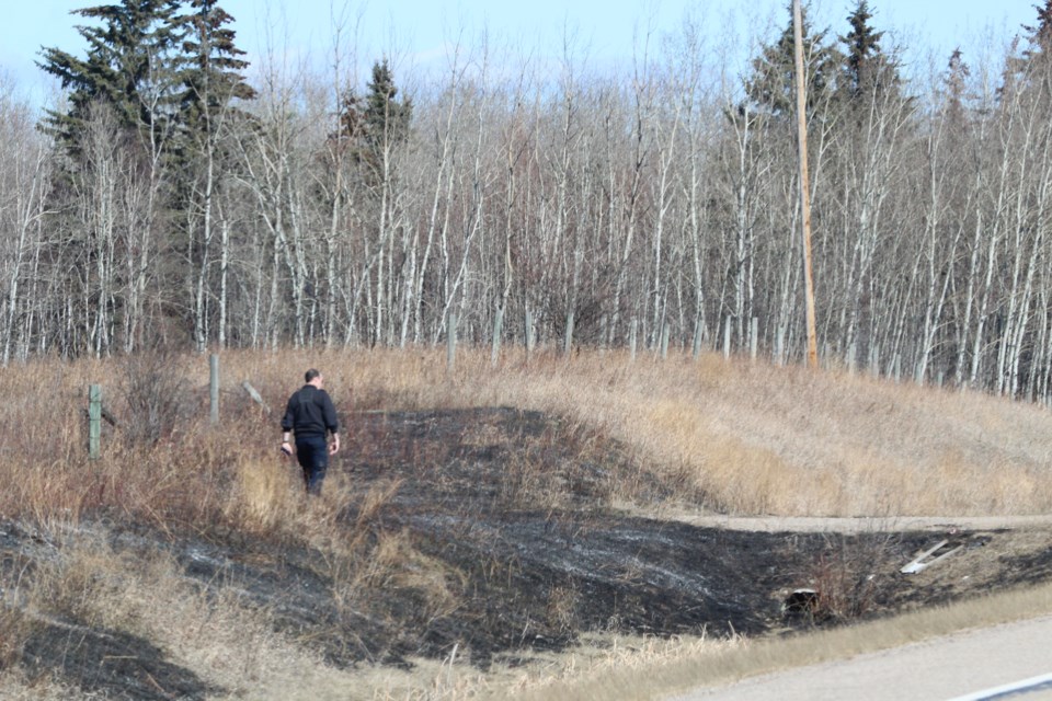Lac La Biche County Fire Services Coordinator Chris Newhook examines a burn area along Highway 55 near Rich Lake on Thursday afternoon. Local fire officials say 2023 is one of the driest first season starts they can remember.