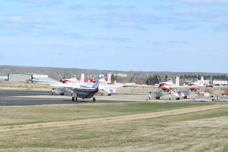 The 'bird-dog' spotter plane and the Air Tractor water bombers at the Lac La Biche Air Tanker base. 