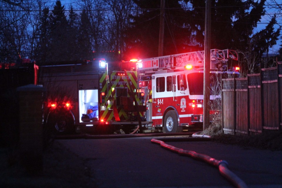 Fire trucks set up on the alley north of 103 Street near Wednesday night's garage fire.