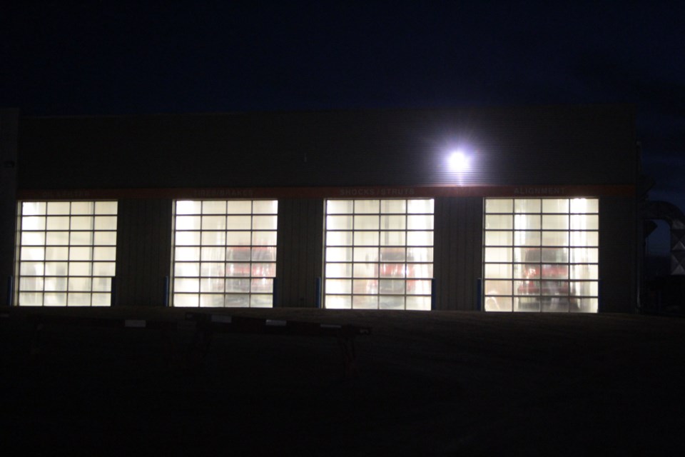 From Ford to fire: Lac La Biche County fire department equipment can be seen behind the large shop doors at the department's new location inside the former OK Ford building on Beaverhill Road in this night-time picture. The building has been retro-fitted over the last two years to house fire, search and rescue, community peace officers and possibly ambulance services.    
  Image Rob McKinley