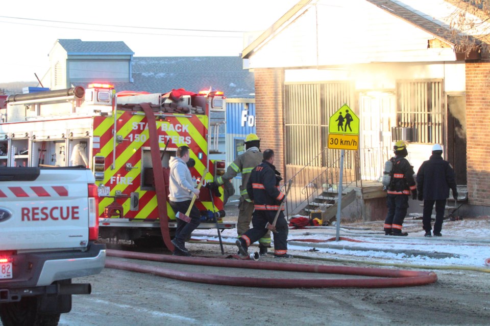 Fire crews were dispatched to the fire just half a block off Lac La Biche's Main Street at about 2:30 pm Thursday. In this image, the neighbouring Fountain Tire business and the nearby Ecole Ste. Catherine school can be seen.