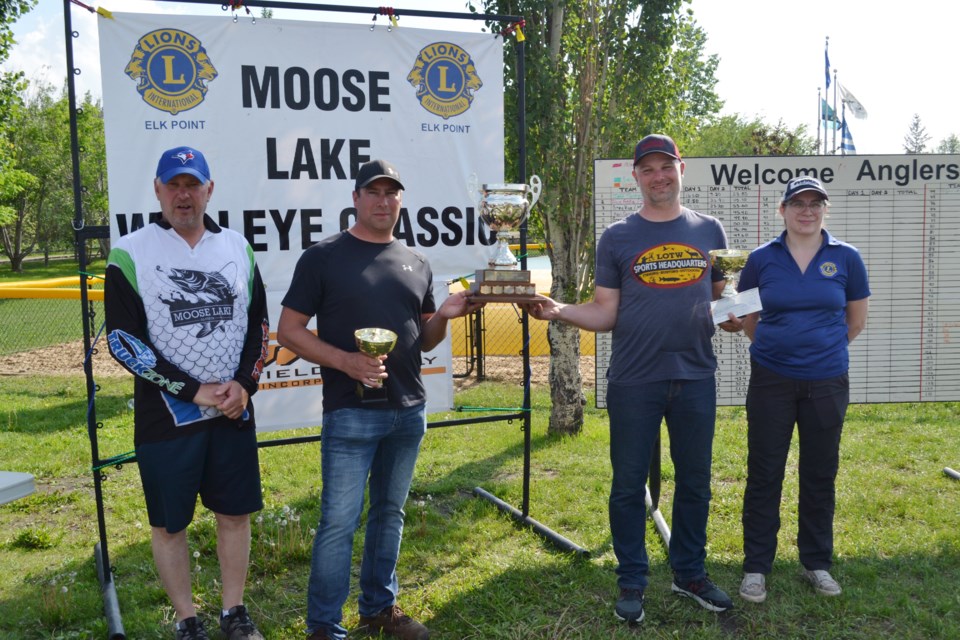 Kevin Schafer and Chris Kindraka were the big winners at the 2023 Moose Lake Walleye Classic with a total catch of 59.40 pounds, receiving congratulations from Moose Lake Walleye Classic chairman George Hahn and a $4,000 cheque from Elk Point and District Lions president Crystal Boorse. / Vicki Brooker photo