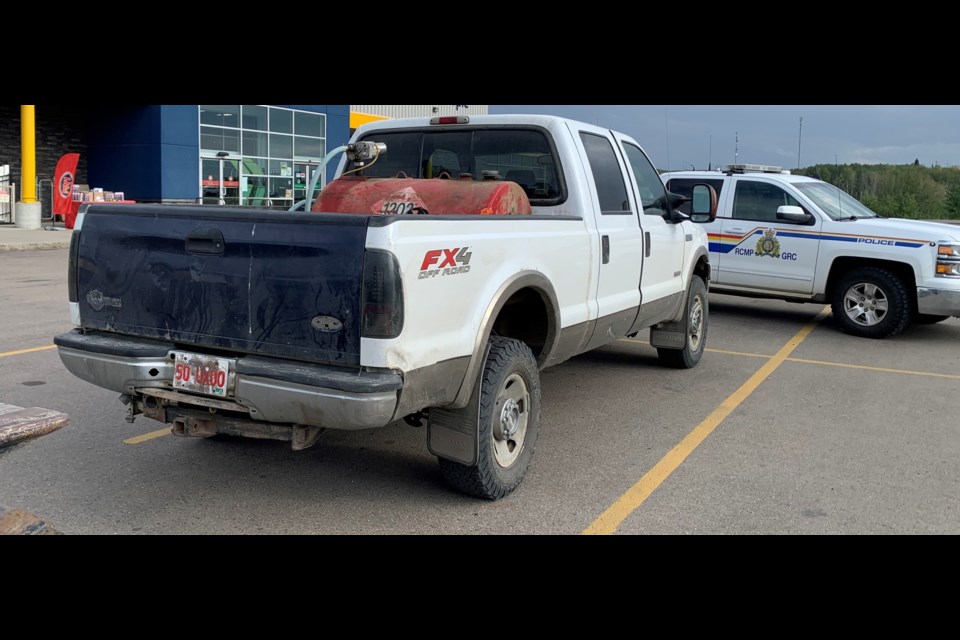 A police vehicle blocks in a pickup truck in a Cold Lake parking lot. The truck was believed to have been linked to suspects in several crimes.  PHOTO: RCMP