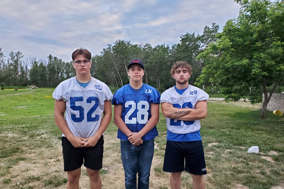 (Left to right) Bonnyville football players and brothers Connor and Liam Critch both made the Football Alberta provincial teams. Here, they post for a photo with their older brother, Duncan. / Photo supplied