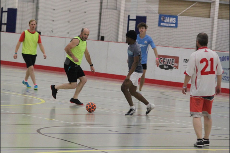 Uchenna Egemasi and Leonard Elponoria make a run towards the ball at the same time during a futsal match that took place at the Bold Centre on Sunday. Chris McGarry photo. 