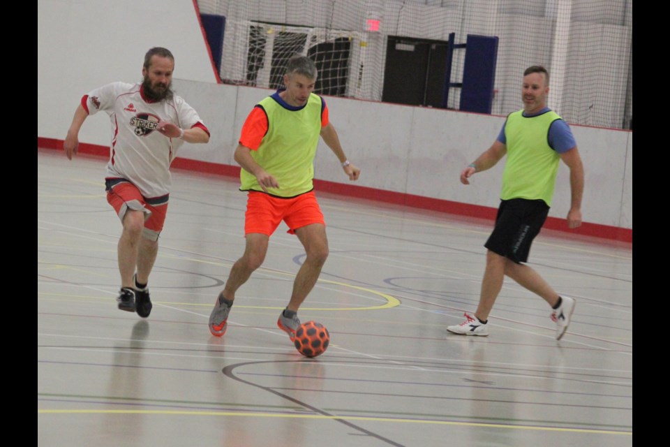 Arseny Kojin stays on Les Grammer as he has control of the ball and moves it towards the opposing team’s net. Chris McGarry photo. 