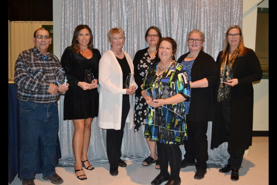 Hats off to Excellence awards winners were, left to right: John Bugej, accepting for grandson Luke Germain (Junior Citizen of the Year), Twila Stafford (Chamber Member Business of the Year), Shirley Harms (Spirit of Community), Jaime Porcina (Business over 10 employees), Shani Jurak (Employee of the Year), Margaret Bayduza (Citizen of the Year) and Desiree Maas (Business under 10 employees. Not shown are Faithe Hunter (Manager of the Year) and Kyle Porcina (Home Business of the Year).