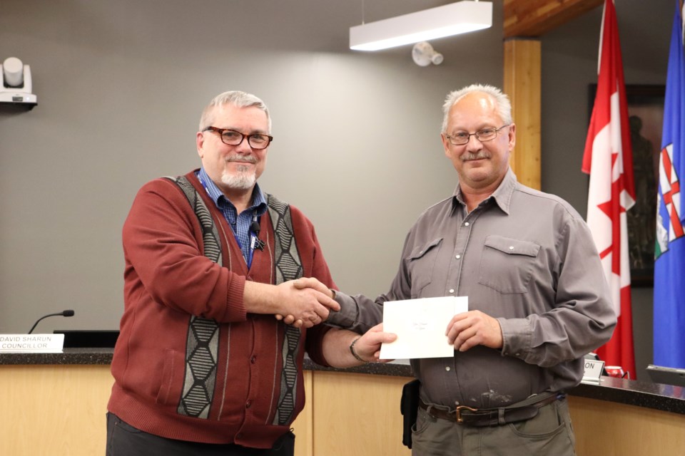 Glen Hassan (right) was recognized for working with the Town of Bonnyville for 35 years. Presenting a token of appreciation is CAO Bill Rogers. / Photo courtesy Town of Bonnyville