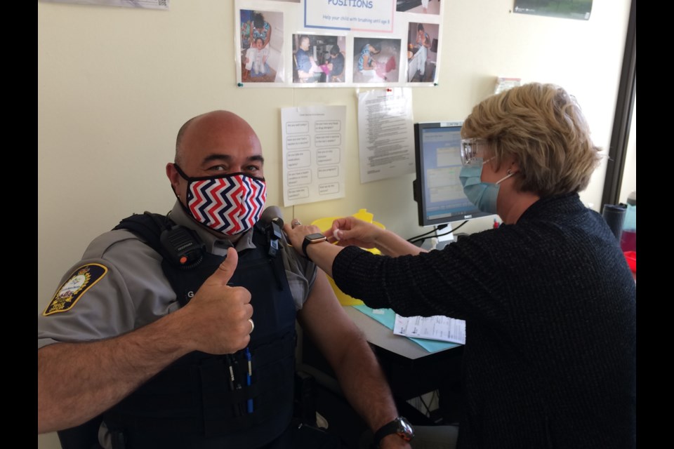 Lac La Biche County Community Peace Officer Glynton Brittain gets his COVID vaccination from Health Unit nurse Jodi Skakun.