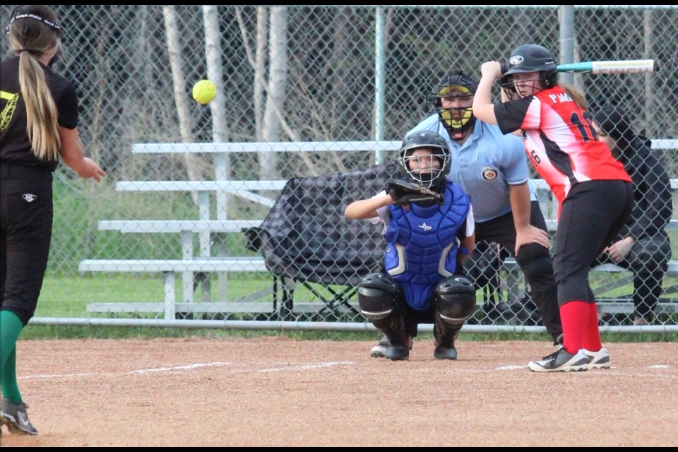 All eyes on the ball; the umpire, the Goodfish Lake catcher and Plamondon batter Chloe Plamondon watch the incoming pitch during a recent U15 Girls softball game in Plamondon.