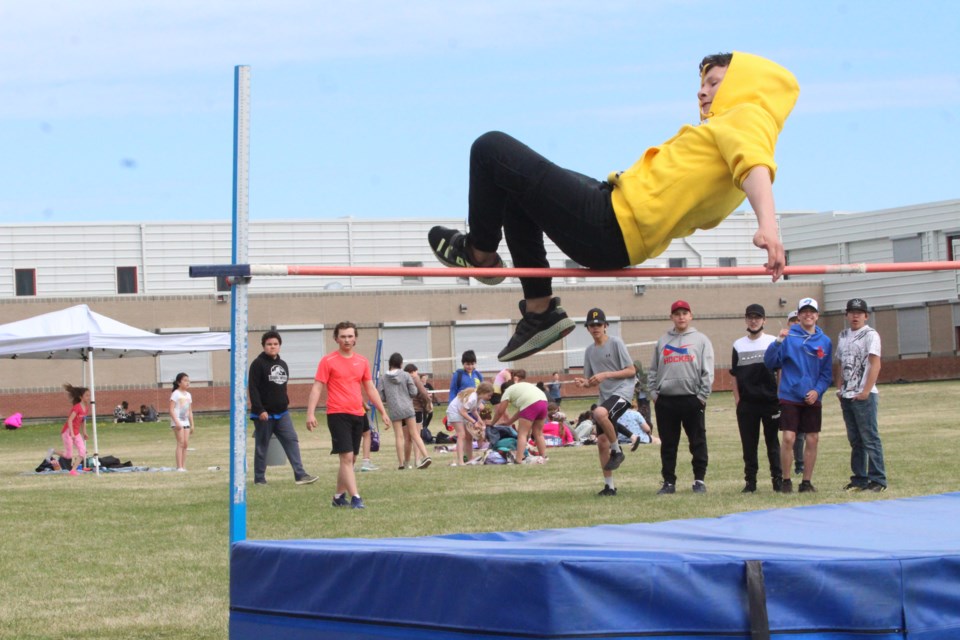 Grade 8 high jumper Gordon Reid clears the bar during the final round of high jump at the Aurora playing field on Monday afternoon. Aurora students competed in three days of track and field events, including running events at the new track at the Bold Center Sports Fields.