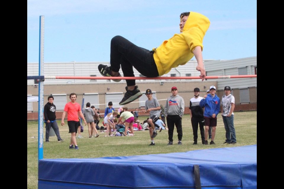 With classmates cheering him on, Aurora Middle School Grade 8 student Gordon Reid clears the bar during senior boys high jump at the Lac La Biche school’s track and field events on Monday. Reid finished the event in second place with a final jump of 1.49 metres. The POST will have more images later at www.lakelandtoday.ca