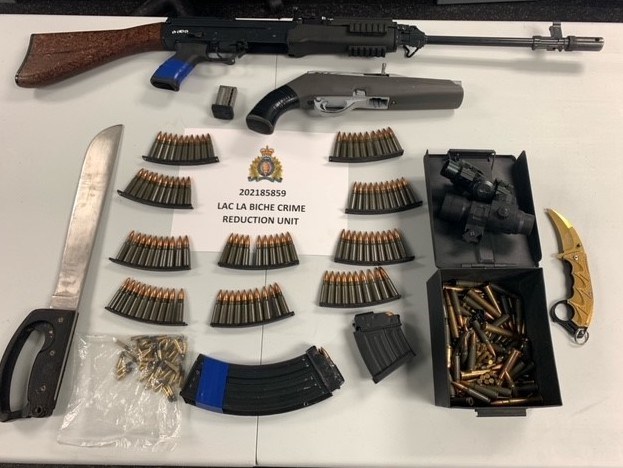 Lac La Biche RCMP Crime Reduction Unit members say these weapons and accessories were found in a vehicle during the arrest of a wanted man this week.    Image Supplied RCMP