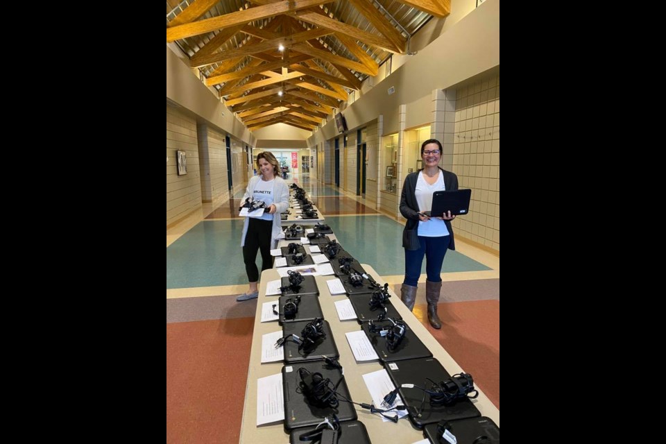 Cold Lake's Ecole Holy Cross staff members Rachelle Poirier and Charlene Harper with the laptops that have been sent out to students.