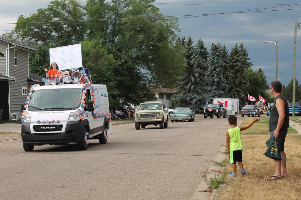 Dark clouds were gathering in the west as the Northern Lights Library System’s Every Child Matters float, classic vehicles and other entries made their way past the Elk Point Curling Club as the Heritage Days parade headed back to its starting point.